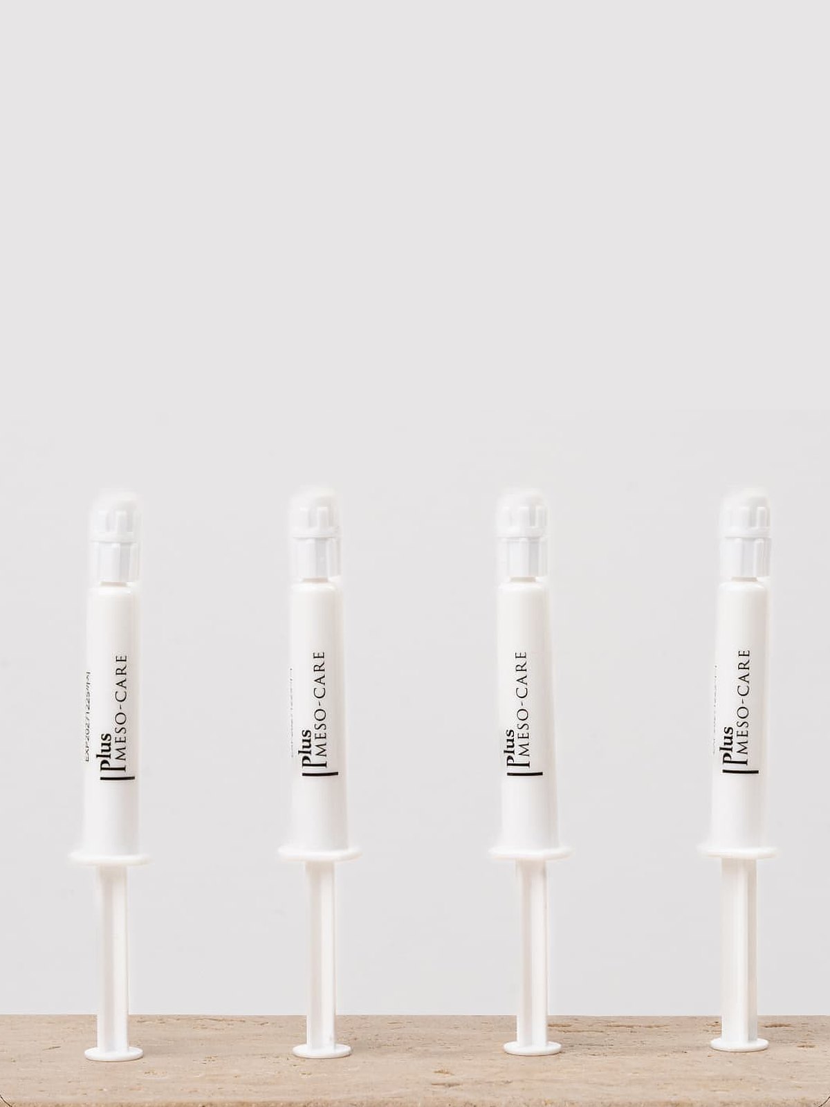 Professional single dose treatment ampoules lined up on a stone shelf